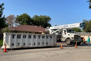 Dumpster used in crane tree removal project